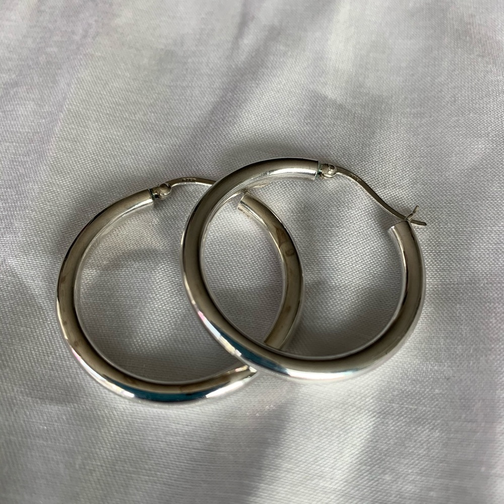 Sterling silver hoop earrings.
